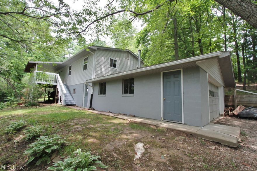 Newer kitchen two full baths, large front deck, newer carpet, 4.85 acres with wooded area, shelter house with electric.