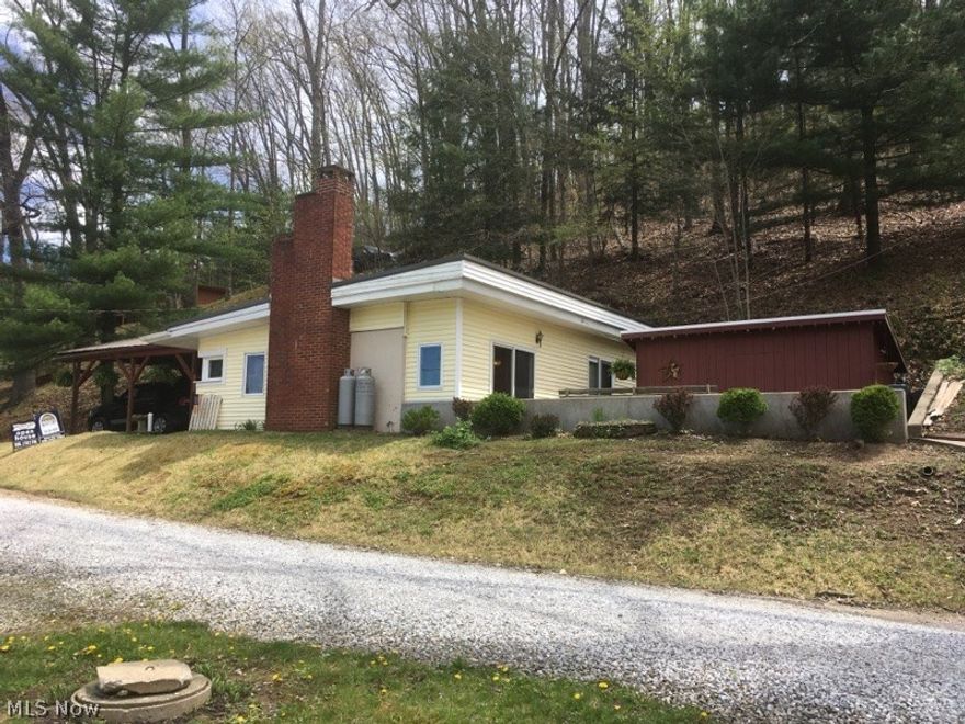 Own your own land at Tappan Lake! Great view of the lake. Living room with woodburner.  Updated interior, oak kitchen with tile floor, sliding doors to patio. 9x15 storage shed. Short distance to the boat dock. Perfect getaway-hunting cabin, nature lovers paradise. Plenty of room to add on. Make an offer! This is not on leased land!