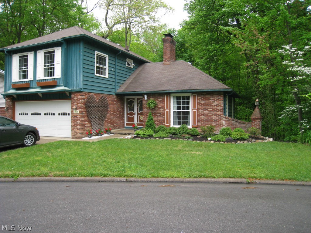 Fabulous views overlooking the Metro Park! Enjoy the peaceful setting of this 3 bedroom 2.5 bath Colonial nestled up against wooded park land. Perfect floor plan includes a large living room with a fireplace and wall of windows facing the woods. A spacious kitchen and eating area open to the deck. Walkout lower level with a fireplaced rec room and plenty of storage. Big and bright master suite with a sunken bedroom, walk in closet and private bath. All new windows in 2005, hardwood floors, first floor laundry, 2 car attached garage and so much more! Must see!