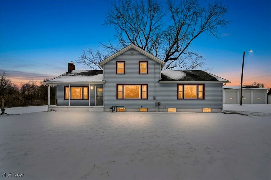 A private oasis in Southington Township, this exceptional 14-acre property features a fully stocked 2.5-acre, 20-foot-deep lake with a private dock-ideal for fishing, swimming, or paddle boating. Thoughtfully remodeled and enhanced with modern updates, the 4-bedroom, 2-bath home offers a welcoming blend of comfort and functionality.

The updated kitchen includes custom butcher-block countertops, a large center island, included appliances, and new LVT flooring throughout. A spacious living room with a wood-burning fireplace insert flows into the formal dining area, perfect for everyday living and entertaining. The first floor includes two bedrooms, including a primary suite with a full bath. Upstairs are two additional bedrooms plus a versatile bonus room ideal for a home office, playroom, or optional fifth bedroom.

Outdoor living is a highlight with a 69×10 enclosed and heated patio added in 2021, a backyard fire pit, and peaceful scenic views. A unique showroom-style gathering space, built in 1999, is ideal for hosting celebrations and events, complemented by an additional 700 square feet of upper-level storage.

Additional features include a heated workshop with updated electric, 220-volt service, wash bay, half bath, and storage room; a 1,000-square-foot storage building for equipment and tools; ample space for boats, vehicles, four-wheelers, and outdoor gear; and a 32×63 three-car garage with loft storage and RV parking capacity. Conveniently located near the Turnpike with easy highway access and just a short drive to Cleveland, this rare property offers the perfect balance of privacy, space, and everyday convenience. Home Warranty Included. Multi-use property as it is zoned commercial.