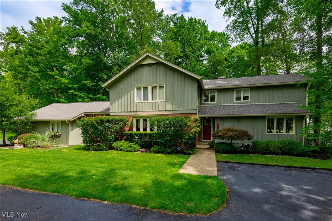Where Mid-Century Modern Meets Craftsman Charm...Tucked into a sought-after neighborhood rich with natural beauty and community amenities, this stunning custom built 5-bed, 5-bath home (3 full, 2 half) offers timeless design, thoughtful updates, and room to live, work, and play. Step inside to discover a completely renovated kitchen featuring a large center island with breakfast bar, quartz countertops, and custom cabinetry—perfectly open to a cozy family room with fireplace for effortless entertaining. A separate formal living room and dining room provide refined spaces for hosting and holidays. A first-floor bedroom with en suite full bath is ideal for guests, cuently used as an office. Upstairs, you’ll find four spacious bedrooms, including a serene primary suite with its own luxurious en suite bath. The finished walk-out basement expands your living space with a rec room, wet bar, game room, and convenient half bath—ideal for movie nights or weekend hangouts. Step out onto the spacious deck and enjoy peaceful wooded views that make every season feel like a retreat. Located in a fantastic neighborhood offering access to a private lake for swimming and fishing, a community pavilion, and scenic surroundings—all just minutes from the heart of Chagrin Falls.
