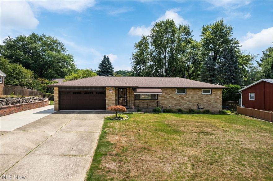 This NE Massillon brick ranch is ready for new ownership. Updates include; new roof, gutter guards and retaining wall. Newer furnace, A/C, tankless water heater and vinyl replacement windows. Large kitchen with oak cabinets, corian countertops, tile floor and laundry. The four season room/dining area is bright and cheery with views of the private fenced in backyard and covered patio. Hardwood floors throughout the hallway and under the bedroom carpeting. There is a half bathroom in the primary bedroom along with tub/shower with large vanity in the main full bathroom. The finished basement provides an abundance of additional sq ft with two living rooms, second laundry area, bathroom plus storage room. Glassblock windows. Large cement driveway, sprinkler and security systems and more. Schedule your showing today as this will not last!