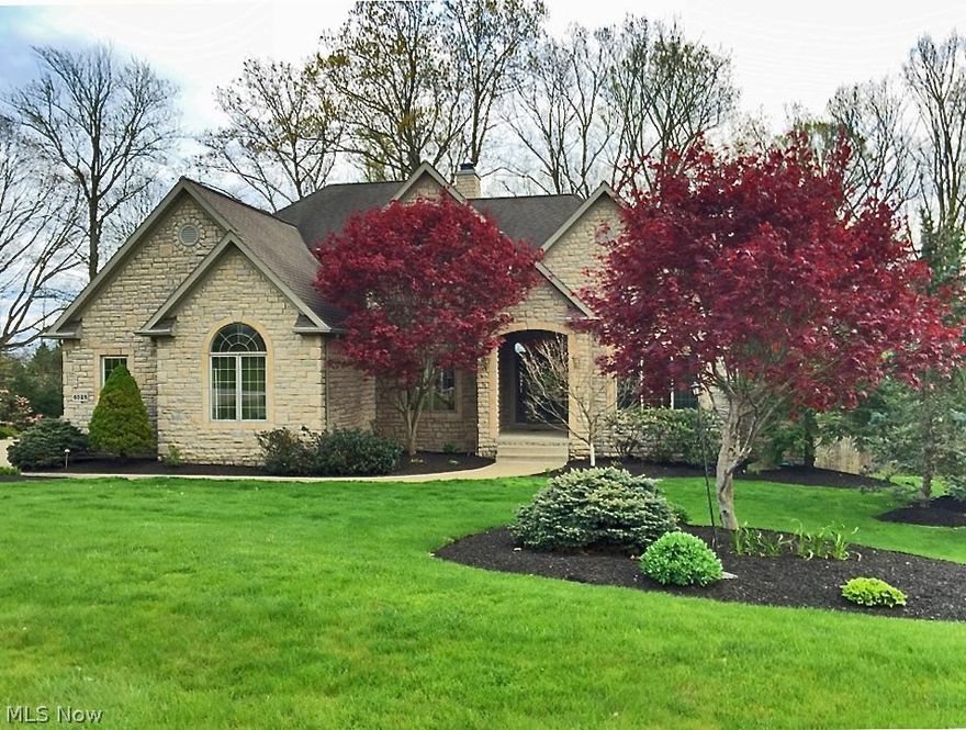 Welcoming 4200 square foot Colonial in Kingsbury Reserve meets all your needs. 4 bed, 4 1/2 bath. Beautiful stone exterior.  Entry with tastefully lighted barrel ceiling welcomes you into this home. Open floor plan. Great Room with fireplace has lovely arched windows leading to deck which overlooks lush backyard. Spacious Kitchen includes a fireplace and hearth area, beautiful bowed window, and center island with breakfast bar.  Beautiful hardwoods in entry, dining room, kitchen, hallways and first floor laundry. First Floor Master with french door entry, trayed ceiling and wonderful Master Bath.  Sunken Jacuzzi tub. Separate his/her vanity areas. Plenty of closets!  Upstairs -3 add'l generous bedrooms and 2 more full baths. Tastefully finished lower level (walk-out) has beautiful center-pillared island boasting incredible storage. Bead board on walls up to chair rail. Lower level is well lighted with 2 large windows, wall sconces and recessed lighting. Lower level kitchen (incl: DW, r