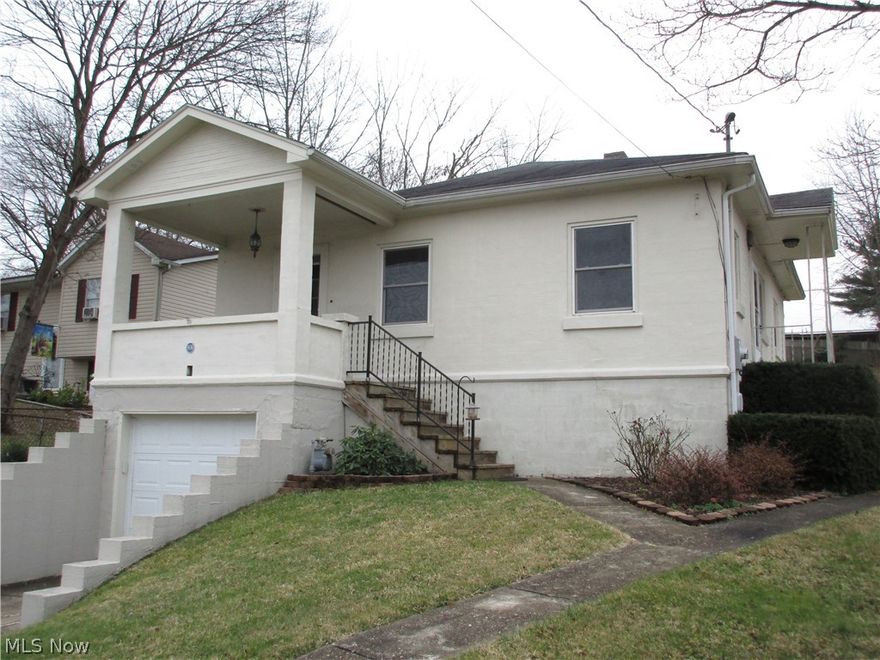 This "cute as a button" 2 bedroom, 1 bath stucco home in Marietta is a rare find.  Relax on the covered front porch in nice weather.  The living room features an attractive gas log fireplace, wood wainscoting and lots of light flowing through.  The lovely new laminate flooring extends into the bedrooms and there is attractive crown molding throughout.  The dining room is open to the living room and offers ceramic tile flooring which extends into the kitchen.  The updated kitchen with access to the outside offers oak cabinets and a lovely new LED ceiling fixture.  The master bedroom has 2 closets.  The lower level has a large laundry/utility room with an additional room that could be used as a bedroom, office, den.  The deep tandem garage has a workbench and is large enough for 2 cars.  The huge back yard is fenced for privacy.  Updates over the past few years are newer windows, new 200 amp service, new central air, crown molding, freshly painted inside with cheery white trim, painted b