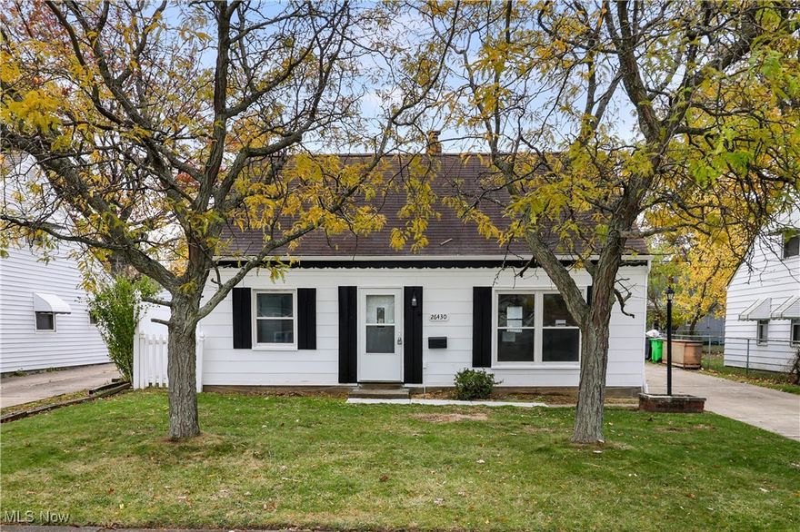 Welcome home to this beautifully renovated Cape Cod in Euclid! Nearly every inch of this home has been updated, offering peace of mind with modern finishes and major system upgrades. Within the past five years, the roof, windows, garage door, hot water tank, furnace, and AC have all been replaced. The exterior boasts incredible curb appeal with its freshly painted white facade, black accents, charming white picket fence, and light post that perfectly complement the symmetrical front yard and mature trees.
Inside, enjoy new light flooring and neutral paint throughout. The spacious living and dining area is filled with natural light from the double front windows, creating a warm and inviting atmosphere. The fully renovated kitchen features all-new appliances, stylish cabinetry, and a striking blue backsplash that adds a fun pop of color. The main-floor full bathroom has been completely redone with modern touches. With four bedrooms, you’ll have plenty of space for an office, playroom, or guest room. The upstairs offers a true transitional Cape Cod layout—ideal for a primary suite or private retreat. The fenced backyard provides a safe and open space for pets or kids, and it’s ready for your personal touch—picture a cozy patio, string lights, and evenings by the fire pit! A two-car detached garage completes this move-in-ready home.