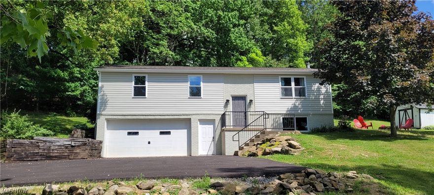 In the hills of Holmes County, this fully renovated raised ranch home has a lot to offer you as a buyer. Located conveniently just 1 mile west of Millersburg, you are near stores, restaurants, the fairgrounds, and the airport. The 1500+ sq ft home sits on 1.91 acres and could be used as your primary residence, or possibly a weekend retreat, or added to your Airbnb portfolio. The inside of the home has been fully renovated and features high quality ProVia doors and windows, new flooring and trim, hardware, and light fixtures. The main level floor plan features a fully furnished kitchen, dining area, living area, a full bath and 3 bedrooms. Downstairs in the finished basement you will find the master bedroom with full bath, laundry nook, and garage access. Outside there is a spacious concrete patio for enjoying those peaceful summer evenings, a fire ring area, and a small shed for yard tools, mower, etc. There is ample space to add another outbuilding if so desired. Updates to the outside include freshly blacktopped driveway, vinyl siding, roof, spouting, and railings. Utilities to the home include newer propane forced air furnace, central air, wood burner (supplemental heat) and private well & septic. This home has been thoroughly and tastefully remodeled from top to bottom and is waiting for its new owners. Schedule your private showing today to view all this property has to offer.