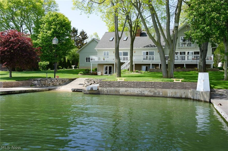 Double Waterfront Home on Johnson’s Island! Spectacular views from the floor to ceiling walls of windows and deck that extends the entire length of the home overlooking Sandusky Bay and Cedar Point! 3 Concrete docks, boat launch, and beach area all at your back door! Sprawling Cape Cod with 5 bdrms, 3 full baths, 4 fireplaces, open floor plan with light & bright coastal décor, spacious and perfect for entertaining! Great room with vaulted ceiling, brick gas fireplace, open to dining area, and open staircase to lower level! Awesome kitchen with cabinets galore, breakfast bar, Cambria quartz countertops, travertine backsplash, induction cooktop, Elkay granite composite undermount kitchen sink, and full pantry! 1st floor private master suite with glamour bath, Jacuzzi tub, custom shower, walk-in closet, and sliding doors to waterfront deck! 2 additional private bedrooms down and 2 bedrooms up with full bath! 1st floor full laundry room! Full walk-out basement with fireplace, overlooking t