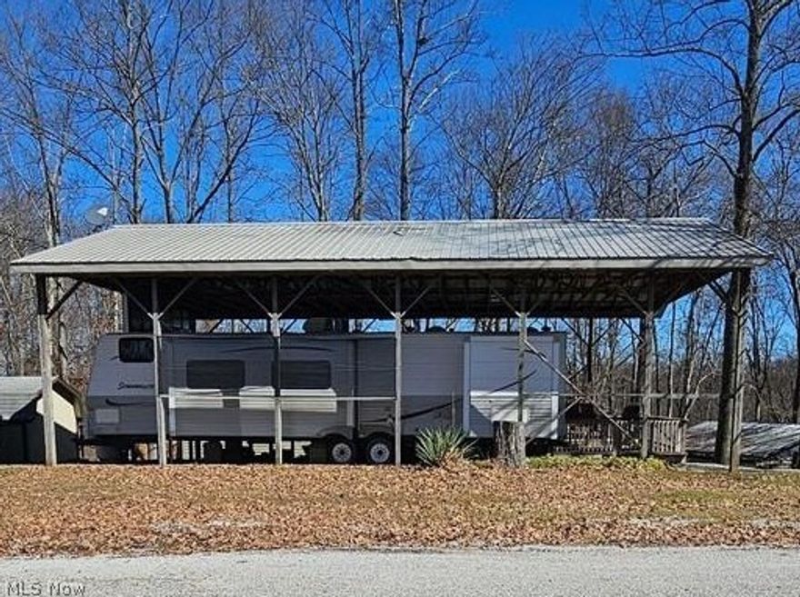 If you are looking for a fantastic place to get away or to even live part of the year, then look no further! Tucked deep into Pikes Peak gated campground community sits this amazing double lot with a gorgeous covered two tier deck with ceiling fans and 16x20 shed with electric (built 2014). The covered deck has a metal roof that extends over the mobile home ensuring longevity of the roof and structure! There are two bedrooms, one featuring a queen sized bed and a second bedroom containing 4 bunk beds. The living room couch folds out into a bed and the kitchen table can be collapsed to the bench seats to make yet another bed so having space for guests to crash is not an issue!! There is a full bathroom but if you are out and about enjoying activities, there  are plenty of comfort stations trickled throughout the park with restrooms and laundry! The main clubhouse hosts many of activities, has restrooms, a hall for events, a game room and also a campground store! All of the activity areas are located at the main clubhouse area. There are basketball courts also used for concerts, horse shoe pits, the pool featuring a shallow and a deep end, bocce ball courts, playground equipment and so much more! If you're looking to hike or ride ATVS and side by sides, there are lots of places to do so, or just enjoy a stroll around the park or to "the point" for breath taking views over woods and our neighboring campground, Grand Haven. Pikes peak is located just a short drive from Saltfork Lake where members of the campground love to go boating and fishing! Do not miss your opportunity to own your own little private oasis at Pikes Peak today! New AC installed in 2020 and 100lb propane tank on lot for heat!