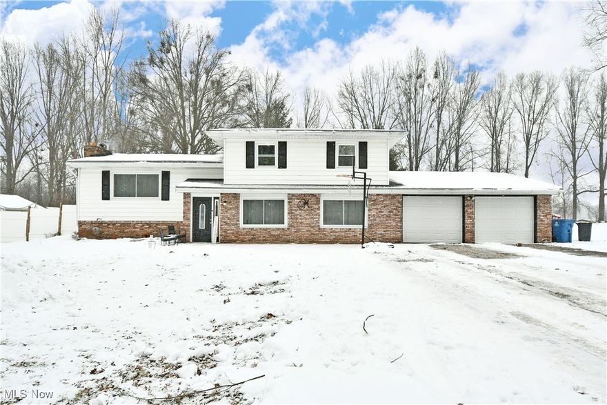 Beat the spring fever with this gorgeously updated Warren residence! Sitting just outside of Lordstown village, this Labrae School district beauty showcases three levels of finished living space throughout its split-level layout! Quick to catch your eye, the home brings plenty of curb appeal with its lower brick façade and attached two car garage with new doors. A decorative, tiled foyer welcomes you inside as sunlight spills out across the wood trimmed staircase. The lower family room delights with hardwood styled flooring and a fantastic cobblestone accent corner for a raised fireplace or whatever your creativity brings. The far doorway opens to a charming full bath and its impressive tile work to include a large walk-in stall shower. Meanwhile, the center hall leads to garage access as a sliding barn door reveals a cozy guest bedroom, bringing the total to four. Hidden basement access steps down to find laundry and storage. Up to the main floor, revel in the striking living room as natural light washes past the crackling gas fireplace. Exposed wood beams line the ceiling for an added touch. Nearby, formal dining stretches around to find a remarkable kitchen, complete with updated appliances, ceramic tiled flooring and stained wood cabinetry. Up the carpeted uppers staircase, a lavish full bath bestows an array of storage solutions along with its elegant tile work before it ties into the corner bedroom for suite access. Two additional bedrooms complete the floor with spacious footprints. Outside, a NEW back patio is waiting for you once the snow melts along with a hot-tub, fire pit area and a fenced-in garden area. Updates include: NEW Back Patio (2023), A/C (2022), Water Softener & HWT (2016), Well Pump (2019), Appliances (2022), Windows & Sliding Door (2023), Re-Insulated Roof/Attic (2017), NEW Garage Doors (2024). Call today for more!
