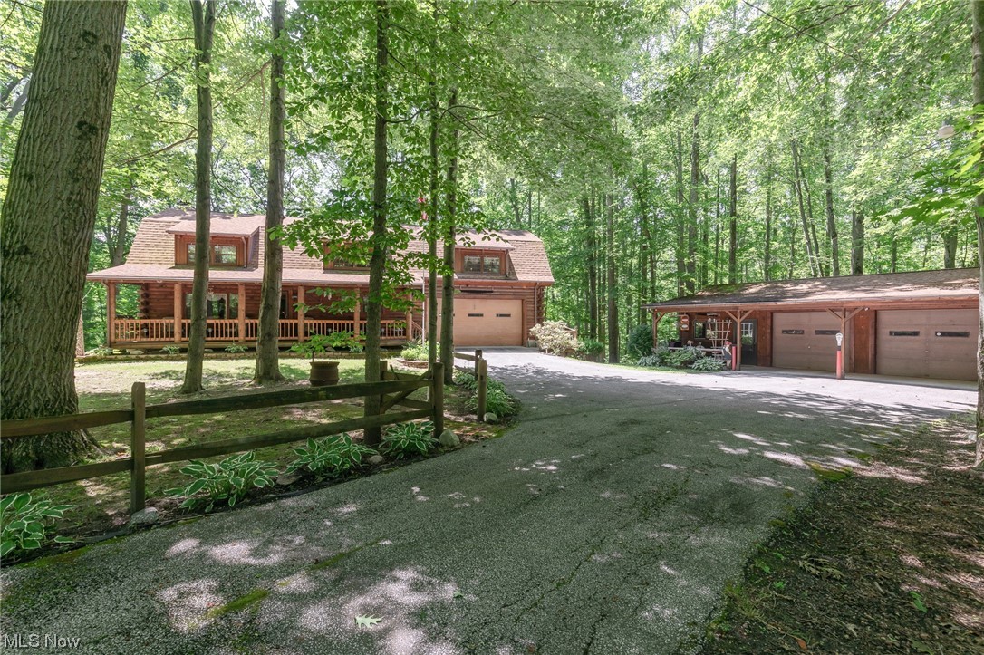 Welcome to paradise in this authentic log cabin home nestled in a tranquil setting. This home offers a unique opportunity to experience it’s charm combined with modern comforts, making it a perfect vacation or permanent retreat and an escape from the hustle and bustle of everyday life. Nearby amenities include wineries, parks, lake lodging, dining options, and various recreational activities, ensuring there is something for everyone to enjoy. Immerse yourself in the beauty of the surroundings, with woodland views and a river that offers fishing and kayaking opportunities. The main living greets with an open floor plan, cooks kitchen with island gathering bar, dining room, natural light, high efficiency anthracite burning stove that creates an ambiance during the colder months, and a sunroom overlooking the wooded backyard and deck. The finished lower level is versatile with full bathroom and kitchen, lending opportunities for multigenerational living or short-term rental options. Ample