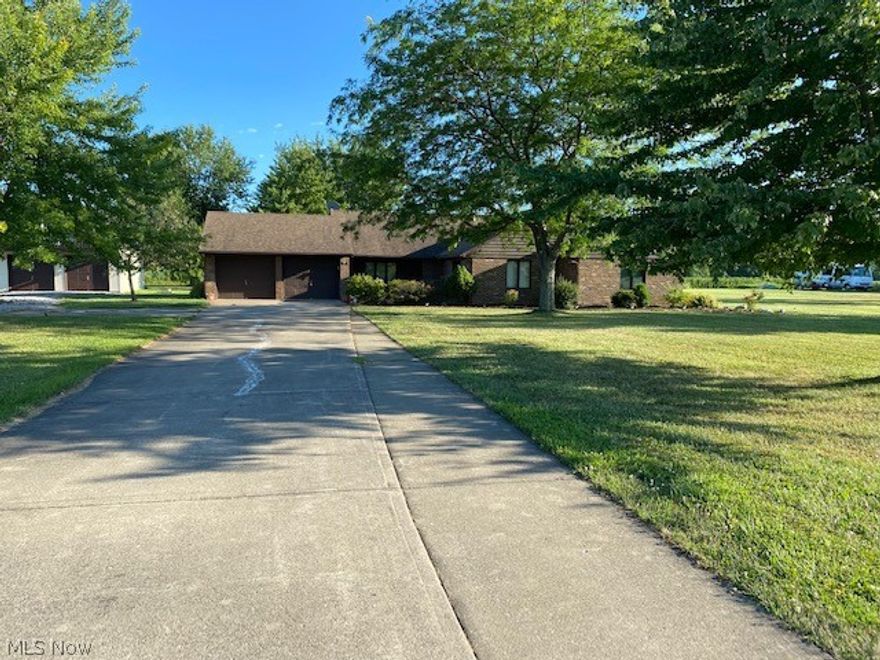 This is a lovely spacious home in a beautiful country setting.    It is near route 2 making it easy to commute to Cleveland. The landscaping is very nice and there is a beautiful pond in front of the house with a fountain.  Bring your fishing pole.  There are fish in the pond. There is a corn field in back of the property so you have a lot of privacy with pretty patio conveniently located off the family room.  Kitchen has nice appliances with the stove being fueled by gas. Foyer is very large with a huge coat closet.  The living room is spacious and conveniently located off the foyer.  Master bedroom has it's own in suite bathroom. There is full bath for the other 2 bedrooms to share and a half bath off the laundry  room.  This is a nice country home located close to the cities.  There is a seperate 2 car garage with Man cave in loft. Owner receiving Homestead.  Roof was redone 14 years ago after they first purchased and roof on 2nd garage was done 4 years ago.