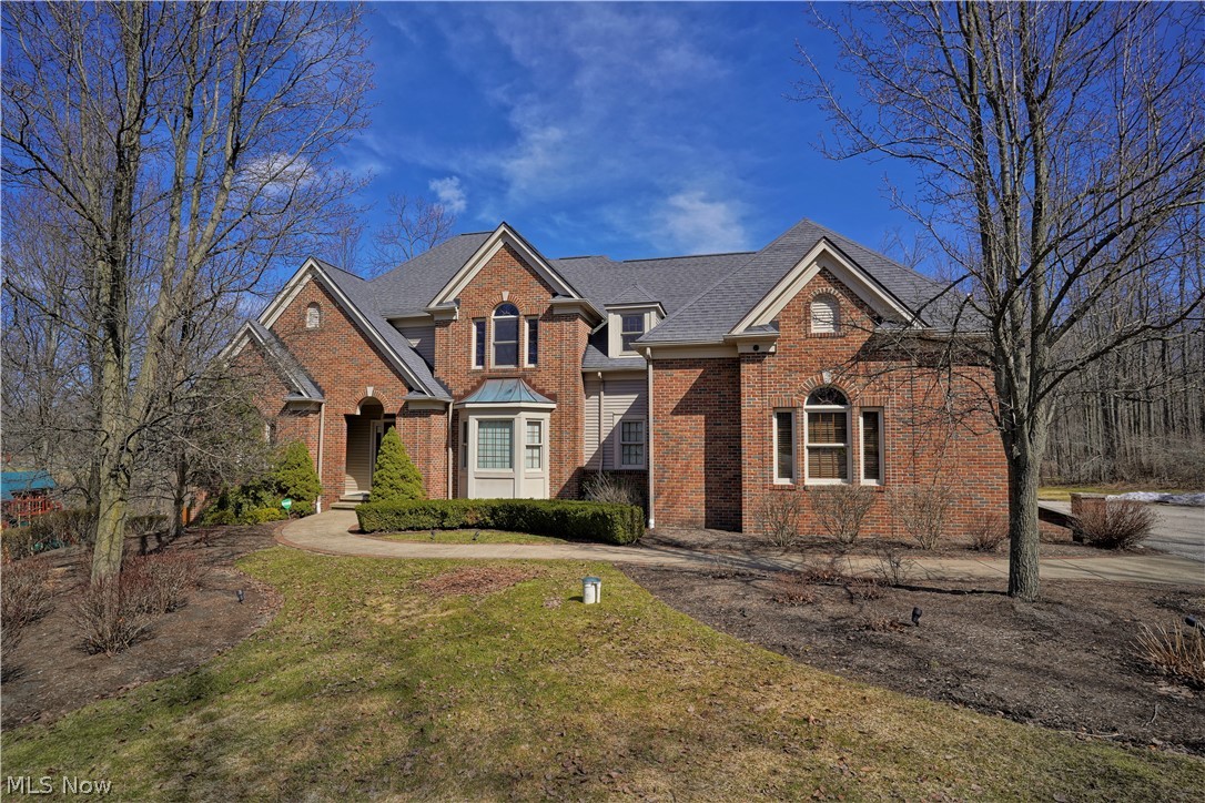 Don't miss this spectacular Payne & Payne custom built home. Beautiful cherry floors welcome you to the two story great room that offer's wooded views thru an expansive window wall and inviting fireplace. The professionally designed kitchen with custom cherry cabinetry, stone backsplash and granite counters will amaze you! The breakfast/dining room is turreted for formal or informal dining. The main level also showcases an office with additional Amish built cherry cabinets and flooring, plus designer half bath. Also "taking your breath away" is the first floor master bedroom with wall of windows & sitting area plus spectacular master bath with more custom cherry cabinetry. The three large bedrooms up with 2 additional adjoining baths have walk-in closets! As you enter the finished walkout lower level (included in the 4456 finished sqft) you will be amazed by everything it has to offer. See thru fireplace to game room & rec room, granite bar, gorgeous half bath & second office or 5th b