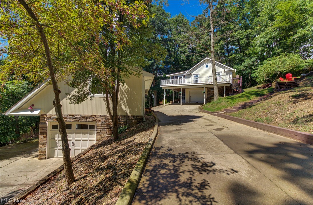 Whether you're looking for a year-round or second home, this home has all the character and charm you are looking for and it's turnkey! This high quality and well designed home has it all....high ceilings, outdoor entertaining areas, multi-use room and so much more. Main level offers an open floor plan with cathedral ceilings that leads to an enclosed porch (34' x 8') along with an adjoining large deck (32" x 12"). Kitchen has a lovely window seat, breakfast bar and custom cabinets. Upgraded full baths on each level. Two spacious bedrooms on the main floor and one bedroom on the lower level. Foyer area on the lower level includes wood burner and ceramic tile flooring. There is also a lower level kitchen/bar area, great for entertaining. The exterior is high quality, low maintenance fiber cement board and stone. Detached garage has upper and lower floors. The upper level room (heated), is currently used as a bunk/recreational room. Main garage (30'x 26'), built in 2007, can hold up to three cars, includes heat and comes plumbed with pipes for an air compressor. Outside enjoy the private setting on an oversized lot with seasonal lake views. Concrete pad next to the lower garage ideal for boat or RV parking. Excellent location surrounded by woods with easy access to the back gate. Lake Mohawk is a private, gated community with a 500 acre unlimited horsepower lake, an executive 9-hole golf course, tennis/pickleball courts, clubhouse and much more.