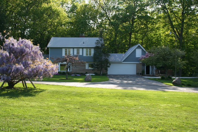 9.8 acres of private setting abuts Lake Metroparks Penitentiary Glen!! This beautiful Colonial home offers hardwood floors throughout. Living room with wood-burning fireplace, family room with wood-burning stove and leads to deck overlooking view of waterfalls. Updated kitchen and baths, many new windows including bay window with window seat and built in blinds, and hot water tank. 1 acre lake with large mouth bass and floating dock. Heated outbuilding has a high overhead door and can accommodate 8 cars or boats, also offers office area, heat, water, and 220 electric. Additional building with outside fenced run. Storage galore- multiple attic area.