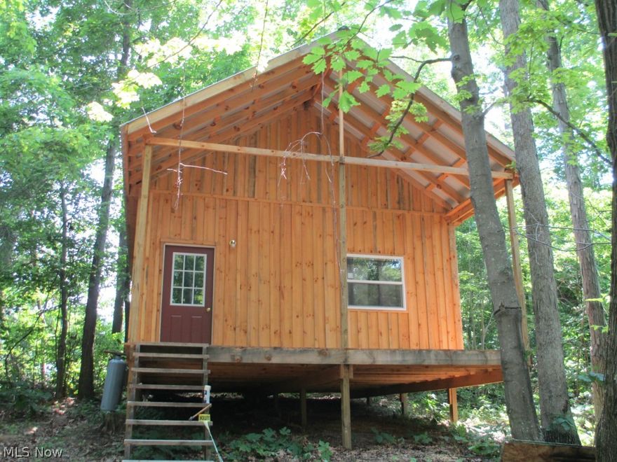 Opportunity and mature timber await on this 4.5 acres located in Noble Local Schools.  Has a new constructed 20 X 32 cabin that is just beautiful and has full bath and kitchen.  All knotty pine interior and an open staircase and loft.  Also a 14 X 70 mobile home that has been rented in past to gas & oil.  Also a New County Approved septic system for multiple dwellings.  This gives many possibilities here.  More room to build more cabins for rentals.  Great spot for a private pond and plenty of wildlife on property.  Just minutes from Seneca Lake and Wolf Run State Parks.  Minerals do not transfer. Also this is being sold as is and cash only. Property can't be used on a loan. Call Agent for explanation.