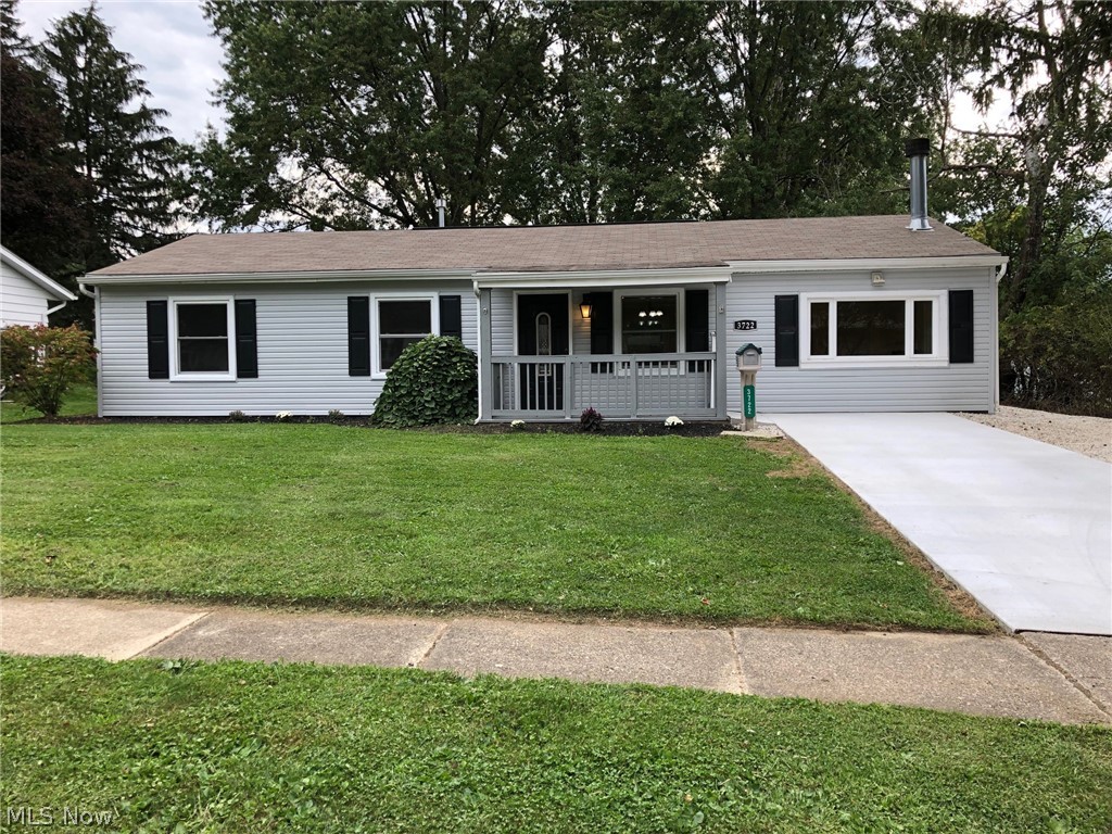 Welcome home to this gorgeous remodeled ranch in a great central location in Stow. Enjoy single floor living at its finest with absolutely nothing to do but move in. Access the front door through the covered front porch into the huge family/living room with wood burning fireplace wired for TV mount. Living room open to stunning kitchen with new flooring throughout tying the rooms together. Kitchen has new solid surface countertops, cabinet hardware, undermount sink with new faucet, white subway tile backsplash, and newer stainless steel appliances. There is also a large laundry room/storage area adjacent to the kitchen. 3 bedrooms with new paint, carpet, and trim with a remodeled full bath complete the house. Fresh paint and white trim/mouldings through entire home. Exterior of home has brand new light gray siding and brand new poured concrete driveway, which is wheel chair accessible to front porch. Large treed back yard with newer shed and concrete/paver back patio. Freshly