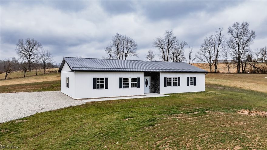 This brand new ranch home isn't just a place to rest your head - it's an invitation to experience life at its finest. Step inside and be greeted by the warmth of luxury vinyl flooring, flowing seamlessly throughout every room. The open floor plan seamlessly blends the living room, dining area, and kitchen, creating an ideal space for entertaining or cozy gatherings with friends.Your inner chef will rejoice in the modern kitchen, boasting an expansive island that doubles as a breakfast bar and meal prep haven. Stainless steel appliances gleam under recessed lighting, while a walk-in pantry keeps all your culinary essentials close at hand. Unwind in the tranquility of the master suite, where a recessed lighted ceiling casts a soft glow. Two additional bedrooms and another full bathroom offer ample space for family and guests, while a dedicated laundry room ensures chores are a breeze. This all-electric home boasts central air and a heat pump for year-round comfort, keeping you cozy in winter and cool in summer. Energy efficiency is king here, with 2x4 walls, 40-year metal roof, R 30 insulated ceiling, energy saving windows, and board and batten vinyl siding all working together to minimize your carbon footprint and utility bills. Rest assured your new home is built to last. The home is built and sits on cement blocks, a poured footer, topped with a sturdy 4-5 inches of cement, then covered in a heat-reflective vapor barrier. No detail has been overlooked in crafting this haven of comfort and security. Beyond the walls of your home, 1.974 acres of land offer endless possibilities. Imagine barbecues on the patio, stargazing from the lawn, or letting your creativity run wild with a garden or fire pit. Priced at just $279,000, 25384 Brimstone Road presents an unparalleled opportunity to own a piece of the Coolville dream. Don't miss your chance to make this stunning new ranch home your own - contact me today and schedule your private showing!