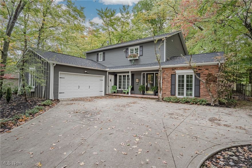 Nestled on a cul-de-sac street and set on a private wooded lot, this charming colonial home in Orange offers a unique floor plan with high-quality finishes throughout. Spanning over 2,400 square feet of living space, this residence features three spacious bedrooms and three bathrooms. As you enter through the front door, you are welcomed by a foyer adorned with hardwood flooring that seamlessly connects to the main living areas, including the dining room and kitchen. The family room boasts a vaulted ceiling, skylight windows, a brick fireplace, and built-in shelving for added storage. The kitchen is a chef's dream, showcasing a custom center island with quartzite countertops, complemented by additional quartzite tile countertops and a full suite of stainless steel appliances. The breakfast nook, positioned in front of triple windows, offers a lovely view of the wooded backyard. Adjacent to the kitchen, you'll find the laundry room and convenient access to the attached two-car garage. The formal dining room exudes elegance with its partially shiplapped walls, while a beautifully designed half bathroom completes the main level. Upstairs, the spacious primary suite features a recently renovated ensuite bathroom that reflects current design trends, additional sitting room can simply be converted into another bedroom or walk-in closet. Two additional bedrooms share a second full bathroom, which has also undergone recent renovations. The basement provides ample storage space, ensuring all your needs are met. Step outside to the fully fenced backyard, where a charming brick patio awaits, perfect for entertaining or unwinding in a peaceful setting.