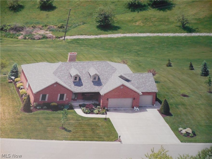 This is a beautiful brick ranch home on almost one and half acres.  The home and yard are well maintained with beautiful landscaping and several of both young and mature trees on the property.  The main level of the home features 3 bedrooms and 3 bathrooms. laundry room, eat in kitchen, formal dining room, a master bedroom with master bathroom with Jacuzzi Tub and full separate shower and 12 x 6 walk in closet, and a half bathroom off of the kitchen and another full bathroom with tub/shower down the hall from the 2 other nice sized bedrooms.  The lower level features another bedroom, walk out family room, workshop plumbed for possible bathroom, and a massive utility room with lots  of built-in storage shelves.  There is a 3 car attached garage, the 2 car garage area measures 27 x 23 and the 1 car garage area measures 23 x 12.  From the eat-in kitchen there are french doors that leads to a two level deck. The lower deck leads to a patio that has french doors that lead to the lower level