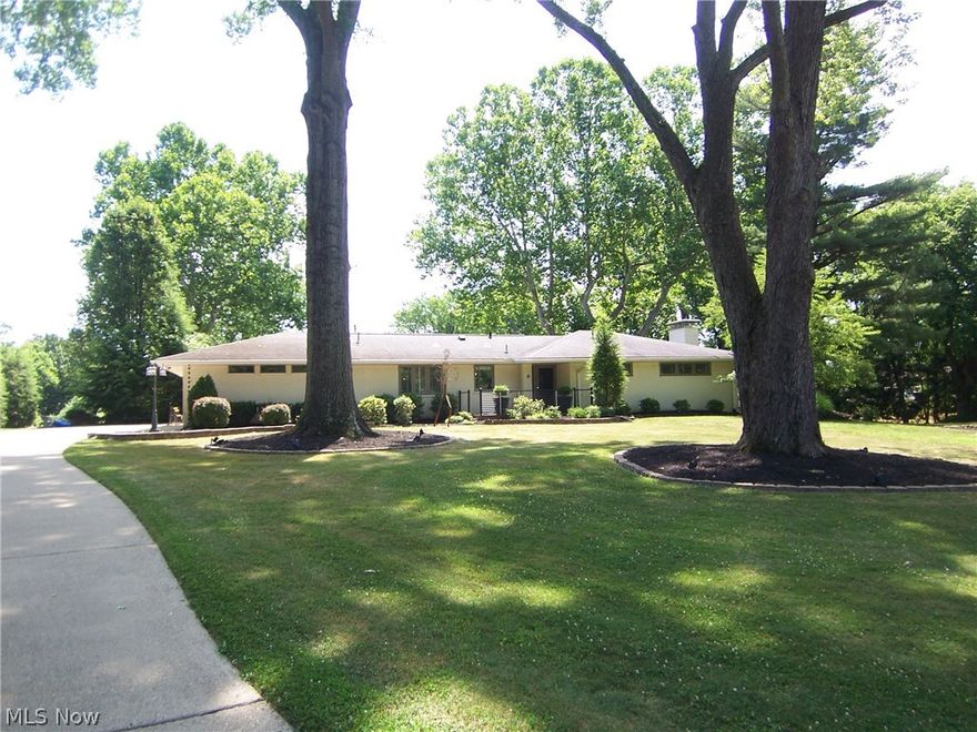 Outstanding updated mid-century ranch with incredible views in one of the most desirable Parkersburg's neighborhoods.  Open floor plan with lots of natural light.  The Amish-made shaker style white kitchen includes custom designed cabinetry and Carrera marble countertops.  Several large windows in the first floor living area frames a tranquil view of the backyard and oversized deck.  The maintenance free Trex Decking and Railing added to front and back of the house.  Shiplap boarding added to accent walls in kitchen, primary bedroom and primary bath.  Updated main floor baseboards to 6" and changed to comtemporary door frames. Interior walls painted.  A newly designed primary suite includes a huge walk in closet that features custom drawers shelving and 28 feet of hanging space. Tumbled stone and slate block shower combine with Restoration Hardware vanities for a modern primary bathroom.  Finished walk out lower level features bedroom, full bathroom and living area with fireplace.  5.1 surround sound system in the living room, primary bedroom, and deck go great with flush mounted speakers and TVs.   Beautiful hardwood floors, stainless steel appliances and many other custom features make this a one of a kind home.  An added control 4 Smart Home System which allows you to control lighting, fans and TV remotely. 65 inch OLED TV was added in 2024.  (Audio components and LR TV are negotiable.