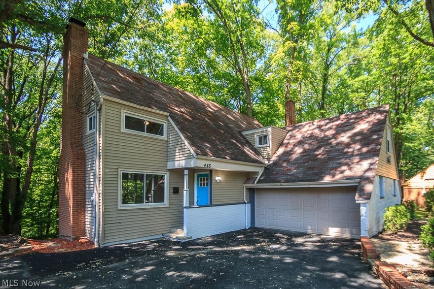 Welcome home and be one with nature and enjoy stunning views of this park like setting.  Move right in to this updated 3 bedroom Colonial with newer kitchen and baths.  Spacious living room with fireplace, hardwood floors and built ins.   Formal dining room with hardwood floors and picturesque views.  Newer kitchen with white soft close cabinets, newer appliances and ceramic tile floor.  3 bedrooms up with hardwood floors.  Master Bath with custom tile shower, jacuzzi tub and double lavatories.  Finished walk out basement with fireplace, large picture window with beautiful wooded views and access to the large deck. Storage area. 
Updated electrical, plumbing and furnace.  Close to UH, Cleveland Clinic, University Circle and downtown Cleveland.  Home warranty provided!