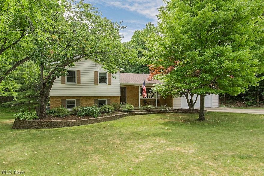 Newly updated in 2017! Shows like a model home!  Owners have spent $ thousands on this South Mentor 4 bedroom, 3 1/2 bath split level on a scenic 1/2 acre lot.  The 24' x 18' 1st floor Great room addition has a breath-taking view of the wooded lot.  You will enjoy the open floor plan as well as the many upgrades: surround sound wiring in the Great room, garage transfer switch for a generator hook-up, extra-large 2-car garage, shed with new roof, newer floors in kitchen and baths, roof (2013), furnace and AC (2006), boiler for addition (2005), windows (2002), all but 2 bedrooms painted recently. 2 Fireplaces: A wood burning with a gas starter in the great room and a gas-log in the lower level family room.  Wood deck with built-in benches adjacent to the Great room.  Also, you may wish to spend some time on the 16 Ft. brick, covered front porch.  Also, beautifully landscaped house in front and rear. Minutes from I 90 freeway and Garfield Park with its pool, playground, tennis, basketball