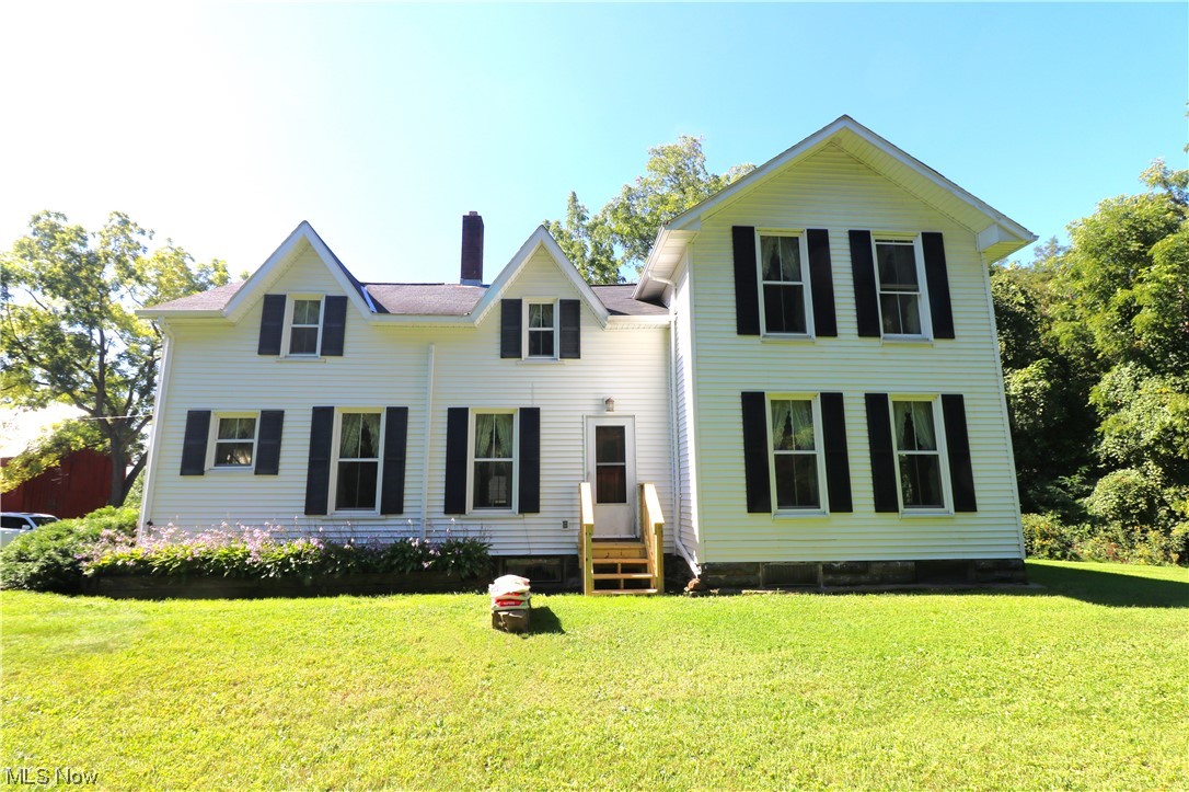 Charming farm house nestled on a private, almost 11 acre lot with wooded ravine! A 2nd floor apartment with both inside and outside access provides a great opportunity for rental income, to help out a friend/family member, or allow an older child more independence. Apartment features its own kitchenette, large bedroom, 2nd bedroom loft area, living room, and knotty pine accent walls. Some hardwood flooring. Main floor laundry room showcases unique saloon-style doors. Start your mornings in tranquility on the spacious covered porch (30x10). Property also includes three outbuildings. Discover the endless possibilities of this remarkable and distinctive property. *Water to barn was shut off at house and they haven't used in a very long time. Dishwasher is NOT included.