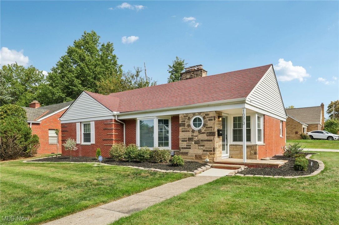 Welcome to 1073 Hereford Rd in Cleveland Heights, located in the historical Forest Hills community. This beautifully renovated brick ranch blends timeless 1950s charm with today’s modern design and features a new fenced in backyard. The staged photos will help you envision the versatile layout for your future furniture placement. Every detail has been thoughtfully updated inside and out with top notch materials and quality of work. Head in through the front door and notice the spacious living room that showcases refinished hardwood floors and a striking wood-burning fireplace with herringbone tile. The open concept offers a bright dining area that flows seamlessly into the brand-new kitchen, featuring Shaker-style soft close cabinetry, quartz countertops, a stylish herringbone backsplash, sideboard serving area and stainless steel appliances, including a counter-depth refrigerator and 5-burner gas range. All of the bedrooms feature rich hardwood flooring and matching wood ceiling fans, with crisp white panel doors and updated hardware provide a fresh, cohesive look throughout. The main bath blends classic white subway tile with an octagon tile floor, accented by a black vanity and brushed gold fixtures for a touch of drama. The expansive lower level offers endless possibilities with the sandstone fireplace with room for a billiards table, a wet bar or a priceless space for movie nights. The spa-like full bath features a walk-in shower with wave-pattern tile, rainfall showerhead, hand-held wand and four spray jets. Every major mechanical system has been upgraded: 95% energy-efficient furnace and A/C, new 200-amp electric panel with updated meter and service line, 50-gallon hot water tank, new plumbing, fully insulated walls and attic, energy-efficient windows throughout, waterproofed basement, sump pump, and more. The 2-car garage with opener has a newer floor and driveway. Ask about the 7 year property tax abatement and schedule your private tour today!