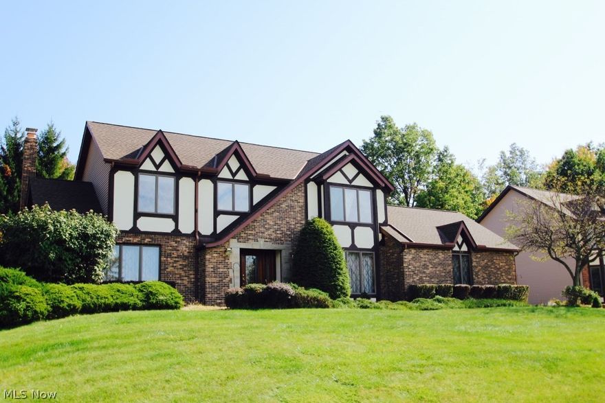 This gorgeous Tudor home w/ 4 bedrooms is built in the beautiful subdivision of North Royalton - Sherwood Highlands. Great location with beautiful neighborhood with manicured lots, perfect for walking pets. Award winning school system. Convenient location to all kinds of shopping and walking distance to a new YMCA. Sprawling 62' Front Elevation w/Side Entry Garage on .3863 Acre Lot with multi level deck. Tiled 4-season Room with Hot Tub and beautiful wood vaulted ceilings. Finished Basement, Anderson Windows. Huge family room w/ fireplace that opens up to the kitchen. Newer granite in kitchen with Stainless Steel appliances. Formal Living & Dining Rooms! First floor laundry, and Over Sized Owners Suite with vaulted ceilings and glamour bath with whirlpool bathtub. Security System, Central Vac, newer roof, hot water tank and furnace. Spacious yard.