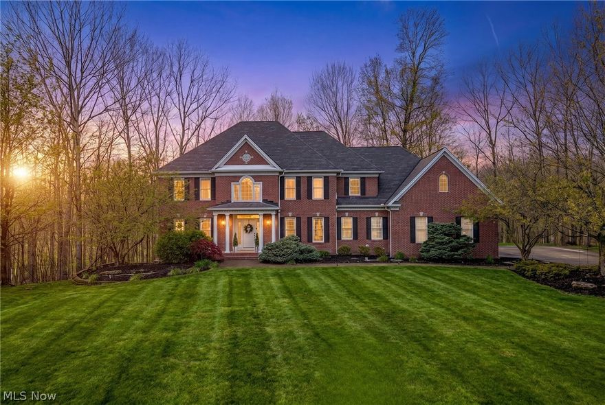 Nestled in the Chagrin Highlands community, this remarkable brick 2-story sits at the end of a quiet cul-de-sac 5+ acres, a private oasis with meadow views & a creek winding to the rear. The 2-story entrance leads to a grand staircase that anchors the central axis, with the dining rm & living rm gracefully flanking the foyer. The great rm is the true heart of the home. It soars with cathedral ceilings & a flr-to-ceiling wall of windows that commands attention, flooding the space with sunlight & greets you with serene wooded views. A handsome fireplace provides warmth & character, while an open flow from the great rm into the updated kitchen creates an inviting, light-filled core for daily living & entertaining. The kitchen features a generous center island, abundant cabinetry, & a sunlit eat-in area overlooking the back deck & tranquil yard. A private study with French doors on the main level offers a quiet workspace, & a convenient laundry//batrm leads to the attached 3-car garage. The formal dining rm, enhanced with refined millwork, is ideal for gatherings, while the living rm provides a welcoming space for everyday living & conversation. The 2nd level hosts 4 bedrms & 3 full baths, highlighted by an spacious primary suite w/sprawling walk-in, a sitting area, 7 a spa-like en-suite featuring dual vanities, a soaking  walk-in shower. 2 bedrms share a Jack-&-Jill bath,  the 4th bedroom has its own en-suite for guests. The finished lower level adds generous recreation space, a 5th bedrm, full bath, work out rm & walkout with access to the yard. Outside, the backyard offers a tranquil backdrop for outdoor living & gatherings w/ patio, oversz deck &noplay area. The home is designed to maximize views and nat light, with easy highway access & proximity to shopping, dining, & the Solon Rec Center. Updates include a new roof, new siding  & furance 2022, tankless H2O, generator & updated kitchen that blends style with everyday practicality.
