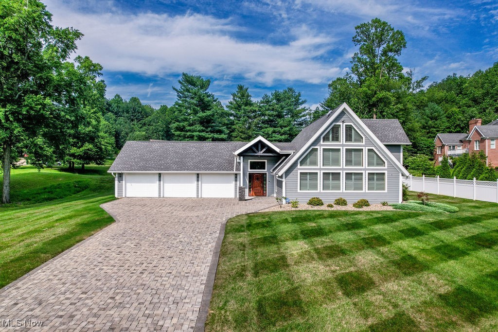 Enjoy casual living in this unique home with wonderful curb appeal. During 2021/22 the interior was totally redesigned, taken down to the studs, and the exterior was also redesigned and redone from the roof to ground. There is too much to describe in this very functional home and the owner can have 1-floor living. Enjoy a spacious great room featuring a 20' ceiling at the center with tongue and groove. The open kitchen is very functional providing commercial range, refrigerator, 2 coolers, oversized island and Quartz countertops. A spacious great room is accented by a full wall of custom plantation shutters on the floor to ceiling windows. You will enjoy the private Master ensuite offering walk in closet, spacious full bath complete with soaking tub, and oversize walk in shower on the main level. There is a 2nd bedroom with private bath area on the main floor and also offers a 1st floor laundry area. and 2 half baths. The loft area provides 2-additional bedrooms sharing a full bath with walk in tiled shower. All interior doors are solid wood 6-panel. Off of the kitchen area for relaxing or entertaining is a 23x23 covered Trex deck complete with built-in storage, permanent gas heaters, gas grill, and enclosed tv plus a 10x23 open deck area. Home includes a newer Generac whole house generator. Situated on a usable .65 acres lot you can enjoy the spacious lawn for events or just enjoy the view. Additional features are sod in front yard, an irrigation system, custom adjustable lighting outlining the eaves, plus a wide paver drive to enter your 3-stall garage. If you enjoy casual living and open space this home is a win-win. Call for your private tour.
