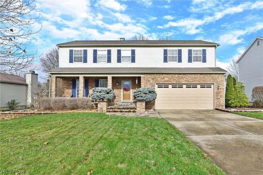 Start your next adventure the right way with this beautiful Austintown home, delighting with three floors of finished living space and a park-like backyard! Nestled deeply into a quiet residential neighborhood, a stylish brick façade and covered front porch quickly draw your gaze as the concrete drive lends to a two-car attached garage. Around back, the tiered patio space boasts stunning stonework as a curving pathway follows along to find a casual fireside gathering. Step inside to find bright colors and bold design choices, all while the dark hardwood style flooring fills the first floor, accented in bright white trim. A carpeted stairway rises from the foyer while a lovely half bath is located opposite the substantial front office or lounge area. The rearward kitchen excites with its multitude of custom cabinetry and stone countertops. A hooded range and stacked ovens complete the look. Casual dining is located across from the patio entry while a posh living room looks on with its b