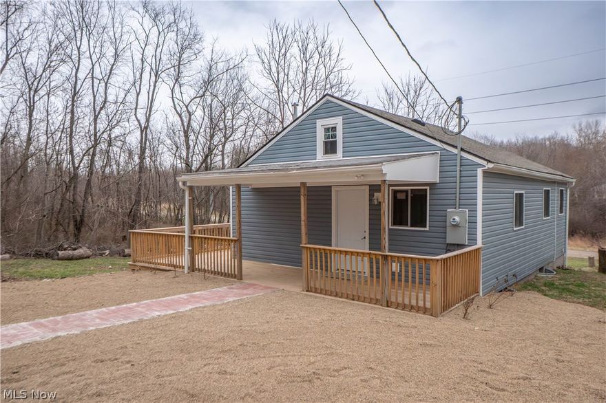 Completely rebuilt and full of fresh updates, this inviting home welcomes you with a brand-new wraparound front porch that sets the tone for the charm and functionality found throughout. Step inside to an open main living area where the living room, dining space, and kitchen connect seamlessly, creating an easy flow for both everyday living and entertaining. New LVT flooring runs throughout the main level, adding a clean, modern look and low-maintenance appeal. The kitchen has been thoughtfully updated with butcher block countertops, tile backsplash, stainless steel appliances, and a breakfast bar for casual seating. Just off the main living space, the main-level bedroom offers comfortable convenience near the full bathroom, which features a tub/shower combination. The lower level expands the living space with a partially finished basement that includes a rec room, a second bedroom, and an additional full bathroom finished with tile flooring, tiled shower walls, and a rain showerhead. A mudroom and laundry hookup add extra practicality, while walk-out access brings flexibility and convenience to the lower level. Outside, the updates continue with new siding, new windows, new electric, and a new roof, giving peace of mind for years to come.