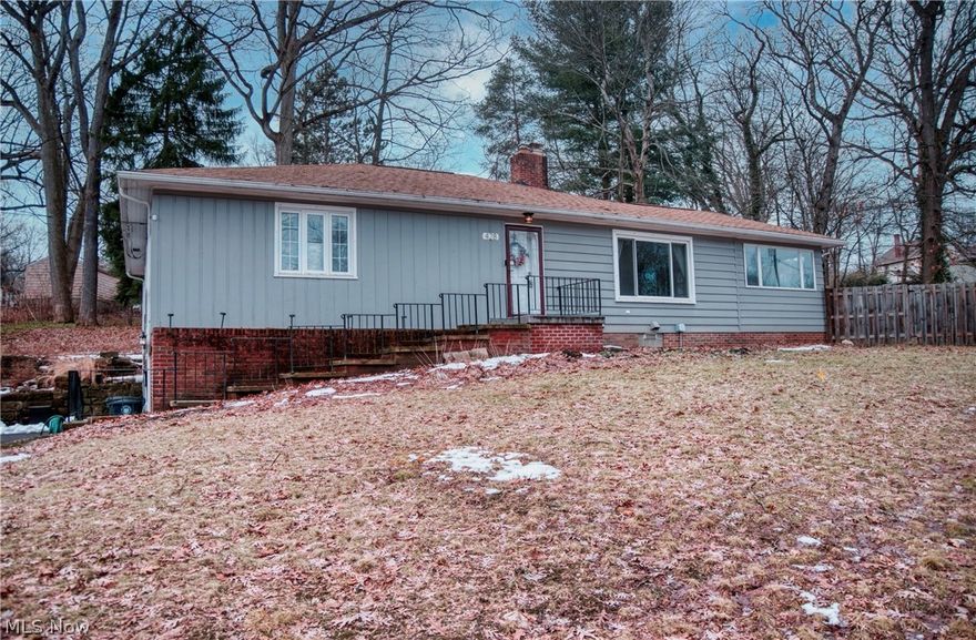Classic ranch home on a rare half acre plus homesite that feels like a luxury in this established Akron neighborhood in Highland Square!  Offering 3 bedrooms, 2.5 bathrooms, approx 2,210 of finished sq ft, and an attached two-car garage with additional space for a gym/storage. Inside you will find a fireplace-centered living room with hardwood floors, a bright eat-in kitchen, two owners suites, and a versatile lower level room with half bath. Updated with custom blinds throughout, this home combines timeless layout with comfortable living spaces. The private backyard and patio are perfect for outdoor enjoyment. Close to dining, shopping, parks and commuter routes, this Akron gem offers space, character and convenience