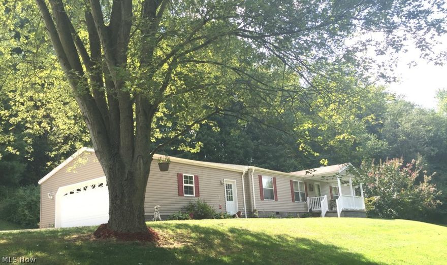 Great Location just minutes to Atwood Lake! This like new manufactured home is taxed as real estate and sits on 1 acre of land. This home has 3 bedrooms, 2 full baths, 1st floor laundry and a 2 car attached garage. There is a bright open concept floor plan with cathedral ceilings. There is a covered front porch and a nice private back deck. Nicely landscaped. The seller is offering a 1 year America's Preferred Home Warranty to the new owner.