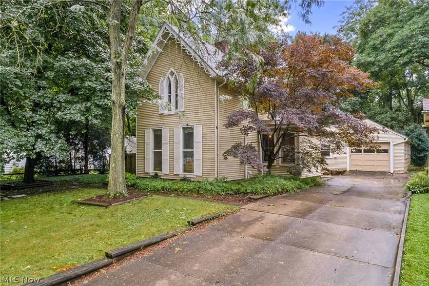 Unique opportunity on historic tree-lined Park Avenue in Kent! One look at this distinctive home, and you will fall in love with its architectural details from yesteryear married with modern features. The large main entry/bonus room and adjacent living room provide endless possibilities and boast original hardwood floors, tall ceilings, and large pictures windows. The living room also features a beautiful stone fireplace with a gas insert and recessed lighting. A welcoming den drips in wood detailing and is the perfect home office with its plentiful built-in cabinets. A formal dining room features newer laminate flooring, built-in cabinets, and provides direct access to a full bathroom and the well-equipped kitchen. Off the rear of the kitchen is a clever addition that includes a family room w/kitchenette, 2 bedrooms, a 2nd full bath and could be used as an in-law suite or rented for supplemental income. The main level also features a convenient laundry/mudroom that leads to the attach