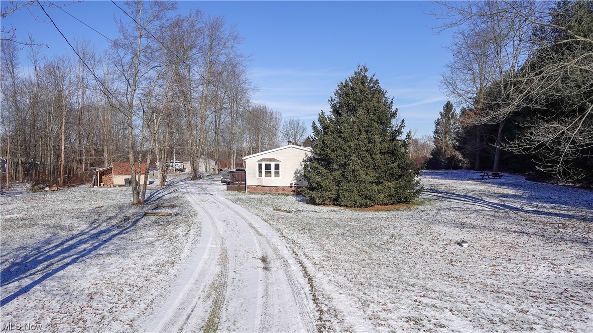 Enjoy country living in this updated home which sits back off the road for optimal privacy. Situated on over 3.5 acres this is the ideal lot. Detached garage is nearly 1500 square feet with concrete floors, electricity and a wood burner. Beautiful front porch or back deck to take in the sights from every angle. Inside you will find new floors throughout. The living room with vaulted ceilings and built-in fireplace opens into the updated kitchen and dining area. Bar seating at kitchen island. Stainless steel appliances stay with the house. The newer wood/coal burner heats the entire house when desired. Master bedroom has a large walk-in closet and private master bath with dual sinks, jet tub, and sky light. Updates include new roof and high efficiency electric water heater in 2023, windows within the last 4 years. Don’t miss your chance to call this home yours!