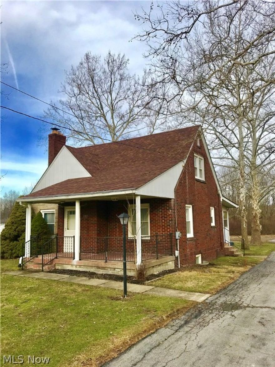 Brick Cape Cod with newer windows, roof & gutters.  Just Waterproofed basement with warranty. Just hooked up to the sanitary sewer and city water.
All hardwood flooring and updated kitchen. All appliances stay.  Baths updated.  Large Living and Dining Rooms.  Fireplace in the living room.
One Bedroom with half bath on the first floor.  2 Bedrooms and Full Bath on the second floor.  Across the whole back of the home is an enclosed porch with an iron stove.  2 out buildings/4 car garage.  Plenty of room to grow.  Almost 2 acres.