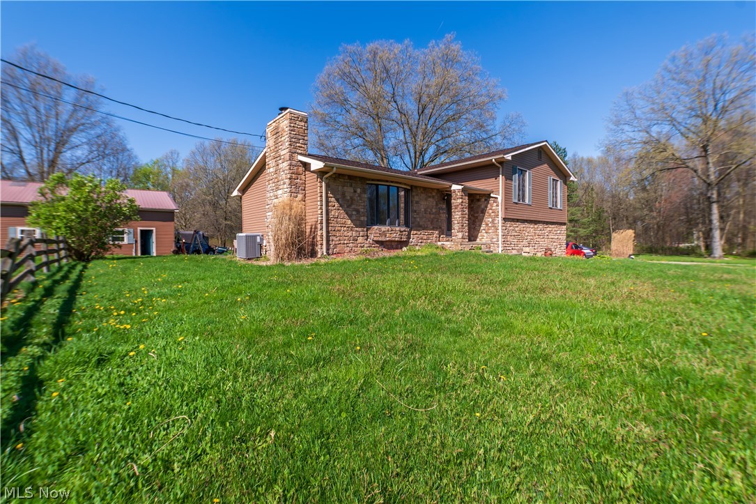 Introducing a stunning split-level home located at 9748 Mount Eaton North in Marshallville. This magnificent property boasts four bedrooms, including a unique double master bedroom as well as two and a half baths. Sitting on a little over three acres, this home has two spacious living areas, one being on the first floor and another on the lower level. Step outside to discover a private pond, perfect for peaceful moments of reflection and enjoyment. The property also includes a two car attached garage and a five car detached garage, perfect for a workshop or a hangout spot for get-togethers this summer. Experience the beauty and tranquility of country living with all the modern amenities you desire. Call to schedule a private showing today!