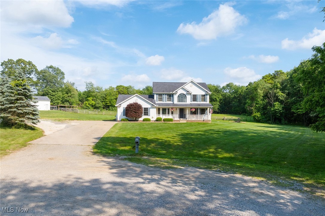 Beautiful four-bedroom home on 5.15 acres, featuring a 32'x40' pole barn with three horse stalls, fenced pasture, and woods perfect for viewing deer and nature. Located at the end of a cul-de-sac in the rolling hills of NW Carroll County, OH. Just 10 minutes from Atwood Lake E. Marina, 25 minutes from Canton, OH, and 30 minutes to New Philadelphia, OH. The home includes a foyer entryway, dining room, and a spacious eat-in kitchen with laminate flooring, breakfast bar, stainless appliances, and a door leading to a covered back patio overlooking the backyard. The first floor also offers a large carpeted living room with LP gas fireplace, half bath, laundry/utility room, plus an additional living space suitable for guests, an in-law suite, or a first-floor master bedroom. This extra space has its own full bath, an independent entryway, and a door to the back deck. Upstairs features the master suite with a walk-in closet and a full bath with a jet tub, along with two additional bedrooms and another full bath. The home also includes a full basement with a bedroom, LP F/A heat, and central air. The high-efficiency LP hot water tank was installed about three years ago, and there is a 200-amp electrical system. The double garage has water access and a 220-amp hookup. The property further includes a 32'x40' pole barn with cement flooring, three horse stalls, and an equipment lean-to on the back side. Fenced pasture space is ideal for your horse, steer, or other livestock. Half-year taxes amount to $2,412.92. Don't miss this opportunity! Call today to schedule a showing or for more information.