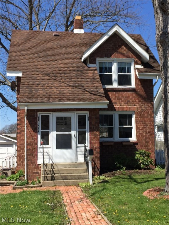 Darling Brick Colonial is in Cuyahoga Falls. Convenient to Route 8, shopping, dining, parks, library, and recreational center! This home has had several improvements in the last few years, including lifetime warranty vinyl replacement windows with the correct architectural grille pattern, paint throughout, kitchen and bathroom floors replaced, and upgrades to the plumbing drain system. A charming brick walkway welcomes you to the enclosed front porch with screened storm windows so you can enjoy the porch almost year round! From the porch, you enter into the spacious living room with beautiful hardwood floors, pleasing neutral paint, and newer energy efficient replacement windows with lifetime warranty. From the living room, you flow right into the dining room with a ceiling fan/light combo, where the neutral decorating continues. The cozy kitchen is off the dining room, and comes equipped with a refrigerator, range, dishwasher, disposal, and Kraftmaid cabinets. A nice oak staircase lea