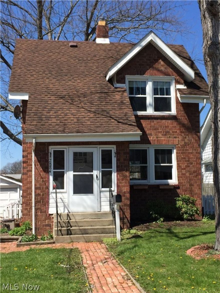 Darling Brick Colonial is in Cuyahoga Falls. Convenient to Route 8, shopping, dining, parks, library, and recreational center! This home has had several improvements in the last few years, including lifetime warranty vinyl replacement windows with the correct architectural grille pattern, paint throughout, kitchen and bathroom floors replaced, and upgrades to the plumbing drain system. A charming brick walkway welcomes you to the enclosed front porch with screened storm windows so you can enjoy the porch almost year round! From the porch, you enter into the spacious living room with beautiful hardwood floors, pleasing neutral paint, and newer energy efficient replacement windows with lifetime warranty. From the living room, you flow right into the dining room with a ceiling fan/light combo, where the neutral decorating continues. The cozy kitchen is off the dining room, and comes equipped with a refrigerator, range, dishwasher, disposal, and Kraftmaid cabinets. A nice oak staircase lea