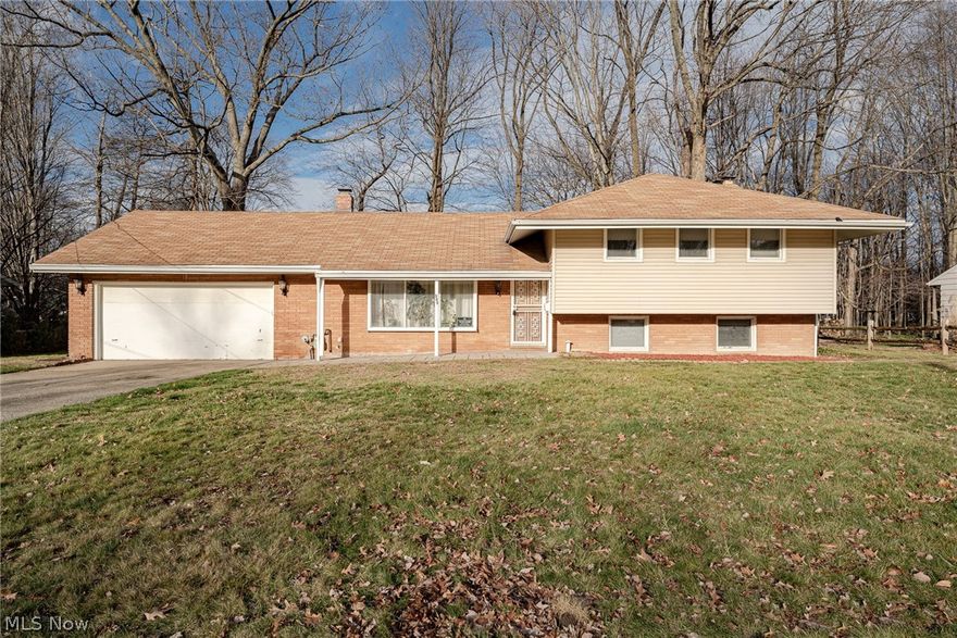 Great opportunity for a spacious split-level home on a quiet street in Richmond Heights! This lovely home features gleaming hardwood floors, an updated kitchen, spacious open-plan living areas, an expansive back yard, and more! The front door enters into a welcoming foyer that opens into the living room. Here you will find a large picture window and hardwood flooring that flows into the formal dining room. The kitchen boasts newer stainless steel appliances, laminate flooring, newer cabinets, and access to the attached 2-car garage. On the upper level there are 3 spacious bedrooms, all with hardwood flooring and large closets. A full bathroom completes the upper floor. The ground level features a spacious family room with wood panelling, a wood-burning fireplace, and a sliding door to the back patio. All it needs is your choice of flooring! A fourth bedroom and a second full bath are located off of the family room. Plus, there is a large laundry and storage room with updated Nature Stone flooring and an egress that ascends to the attached garage! Outside, there is a very large, fully-fenced in back yard! Conveniently located just minutes away from highway access, Euclid Creek Reservation, and several shopping areas. Motivated seller, welcoming any offers! Don't miss this one!