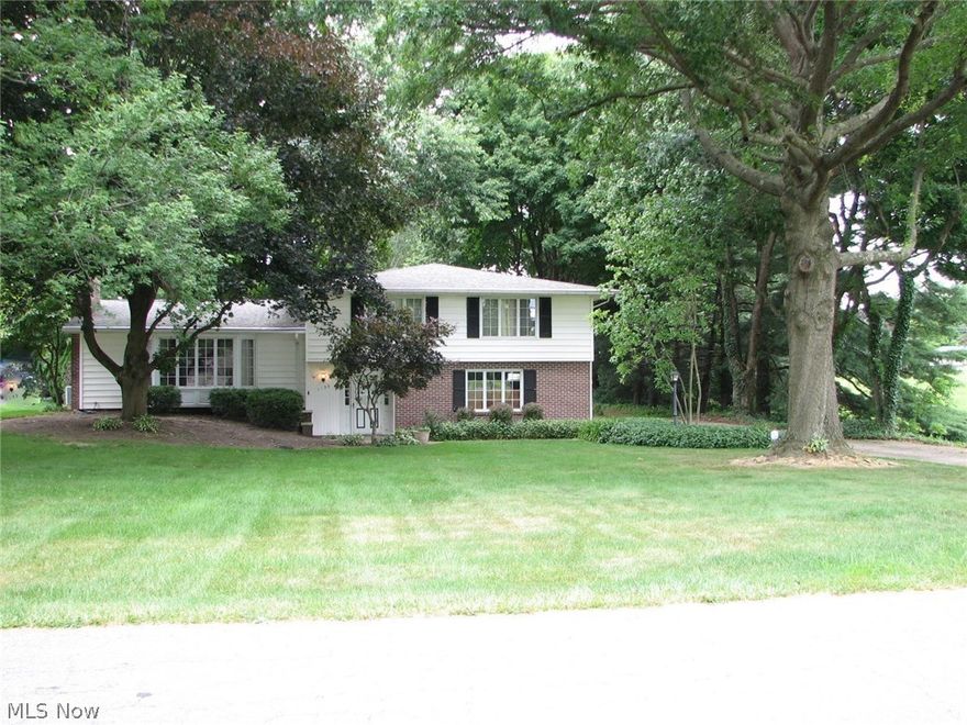 Come inside and take a look at this spacious 4 level split.  Special features include a cathedral ceiling in the living room with fireplace, a family room/den leading to the heated and cooled sunroom, and a master bedroom with private bath, double closet and a walk in closet!  There is no lack of storage and closet space throughout.  The kitchen has a solid surface counter top, lots of cupboards and comes with appliances.  You'll love the layout and large rooms.  The two car garage has an attached workshop.  Wonderful park-like, peaceful setting on a double lot in the heart of Perry near Summerdale Park and the Exploration Gateway at Sippo Lake.