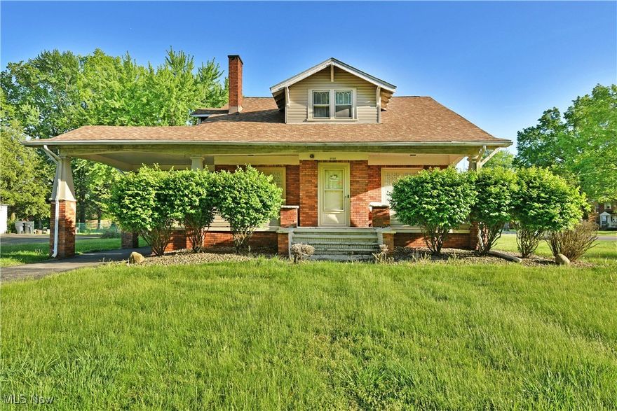 Surround yourself in the elegant styling and profound potential within this remarkable Warren residence! A community staple, this turn-of-the-century estate sits prominently on its corner lot, showcasing its handsome brickwork; warmed by the midday sun. The wrapping driveway runs beneath an extended roofline awning for bespoke vehicle access, adding to the curb appeal as it transcends a four-car detached garage before finding common side street access.  The main entry to the home finds covered patio space as overlooks the front yard and its tall, privacy yielding trees. A lattice window vestibule opens into a breathtaking living room where hard wood flooring flows out to find a casement lined mantle and inset fireplace. Tall windows veil soft, natural light through their venetian blinds. Nearby, the formal dining room offers elegant meal space beneath its shimmering chandelier. Sculpted archways mark the impressive kitchen and its cherry-colored cabinetry. Opposite, a pair of first floor bedrooms are divided by a tile lined bath. A wood trimmed, sunken family room completes the floor with a second fireplace and stairway access to the main upper suite. Upstairs, a colorful bath showcases a dual vanity as it offsets the expansive master bedroom. Meanwhile, the second staircase rises from the dining room and places you within a full secondary set of living accommodations to include a full kitchen, three bedrooms and an adjoining full bath. Storage, laundry and rec areas are located at the basement level.