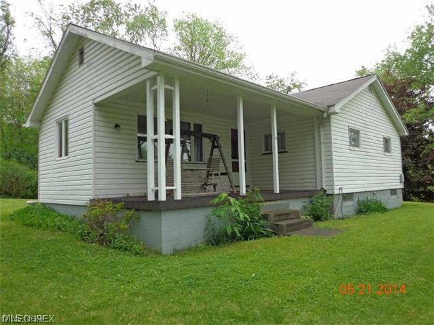 Country living close to the city. Home sits back from the road on this pretty treed lot,  Nice starter home or for someone who wants to downsize.  Big front porch and plenty of garage space.