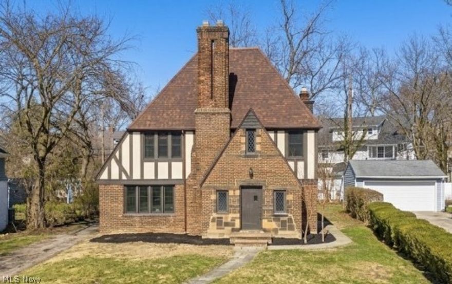 From the moment you arrive, this Shaker Heights Tudor makes a quiet yet unmistakable statement. Its stately brick facade, steep gables, and classic half timbering evoke a timeless architectural heritage that feels both distinguished and enduring. Inside, the home unfolds with warmth and grace, where refinished hardwood floors and fresh interiors are illuminated by an abundance of natural light that pours through thoughtfully placed windows, casting a soft glow across each room. Nothing has gone untouched, with attention to detail evident throughout and updates completed in a way that feels thoughtful and tasteful, enhancing the home’s original character rather than competing with it. The great room, anchored by a fireplace and framed by original French doors, offers a sense of intimacy while remaining effortlessly connected to the dining room and sunroom beyond. These spaces flow with intention, creating an atmosphere that feels open yet purposeful. The sunroom, bathed in light, becomes a daily retreat. The renovated kitchen balances refinement and function, featuring white shaker cabinetry, quartz countertops, stainless steel appliances, tile flooring, and curated lighting selections that complement the home’s timeless appeal. Upstairs, the primary suite offers comfort and privacy alongside an updated Jack and Jill bath, while three additional well proportioned bedrooms are complemented by another fully renovated full bathroom, providing flexibility and ease for everyday living. The third floor presents exceptional versatility as a private suite, studio, or retreat, complete with a bedroom and full bath highlighted by a timeless clawfoot tub. Beyond its beauty, this home offers true peace of mind, beyond POS compliancy, has a complete tear off new roof, gutters, windows, and a freshly seal coated driveway. Positioned within walking distance to Shaker Heights schools and moments from local amenities, this is a home defined by light, presence, and quiet permanence.