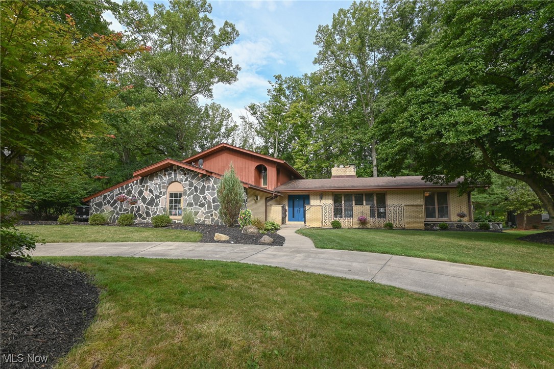 Welcome to 8630 Hollis Lane. A large, updated split-level located at the end of a mature & treelined street in one of Brecksville's most desirable communities, Bradford Village. You are first welcomed into a generous, sunlit foyer, complemented by a refined sitting room to the side. Throughout, you will find a spacious and thoughtfully designed layout featuring the primary suite accessible by just a couple steps on the main level. The open living areas are filled with natural light, highlighting the home’s fresh updates and modern finishes throughout. Upstairs, three additional bedrooms provide ample space for family, guests, or a home office. The partial basement offers extra storage or potential for a hobby space, while the updated kitchen and baths ensure move-in readiness. Nestled among mature trees, the property offers stunning wooded views and a large deck—ideal for relaxing or entertaining outdoors. With its combination of modern updates, flexible living spaces, and a peaceful setting, this home is ready to welcome its next owner.