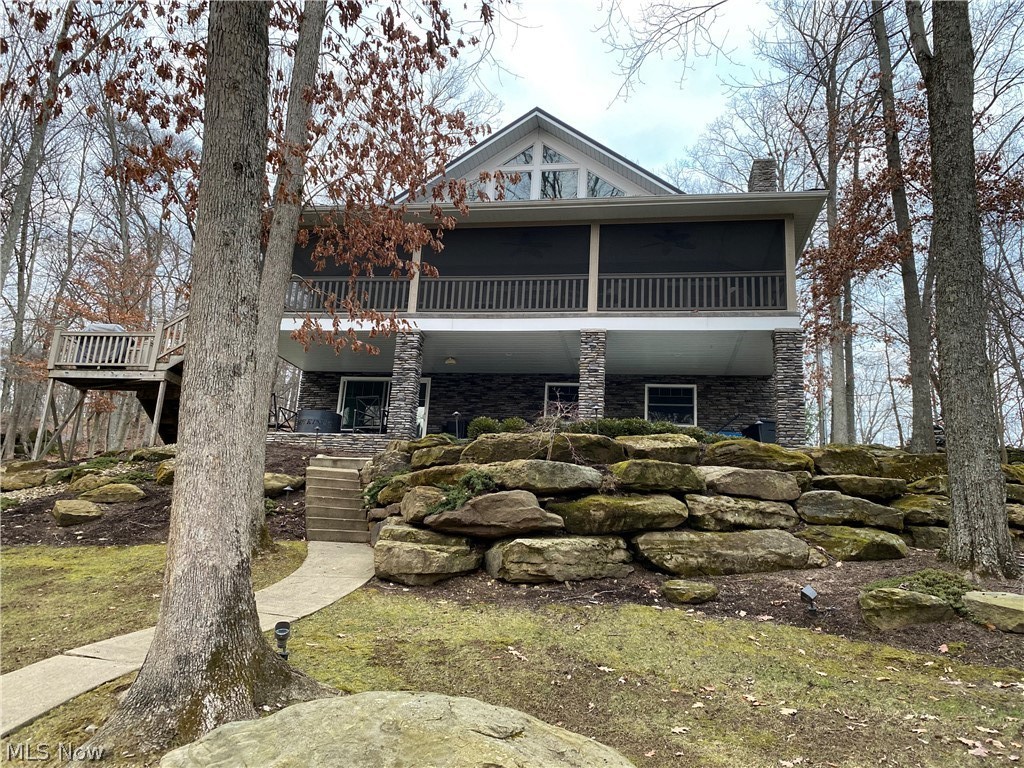 BEST OF EVERYTHING...LAKE LOCATION, STYLE OF HOME, FLOORPLAN, GREAT FULL LAKE VIEWS but w QUIET JUST INTO NO-WAKE ZONE and an EASY RELATIVELY FLAT AND SHORT WALK from the HOUSE TO THE LAKE/DOCK. If not the BEST Property at Lake Buckhorn, certainly one of the BEST! This home built by Walnut Valley in 2014 sits on a beautiful 0.80 Acre lot w 183 feet of Lake Frontage (equiv. of 3 lots) & spectacular views is being sold TURNKEY for everyone's convenience. It has been incredibly custom landscaped w huge rocks/boulders by "hard scape" specialist Totally Outdoors to provide a comforting lakehouse setting. It features large rock formations front & back, cement walkway to the stone patio with firepit down by the dock, large maintenance free decking on dock, & boathouse. Lakeside lawn area you can enjoy for recreation. Not a common steep sloping Buckhorn lakefront lot. The open floorplan home is so tastefully done in the beach chic style that most everyone loves and wants today. There is a hu