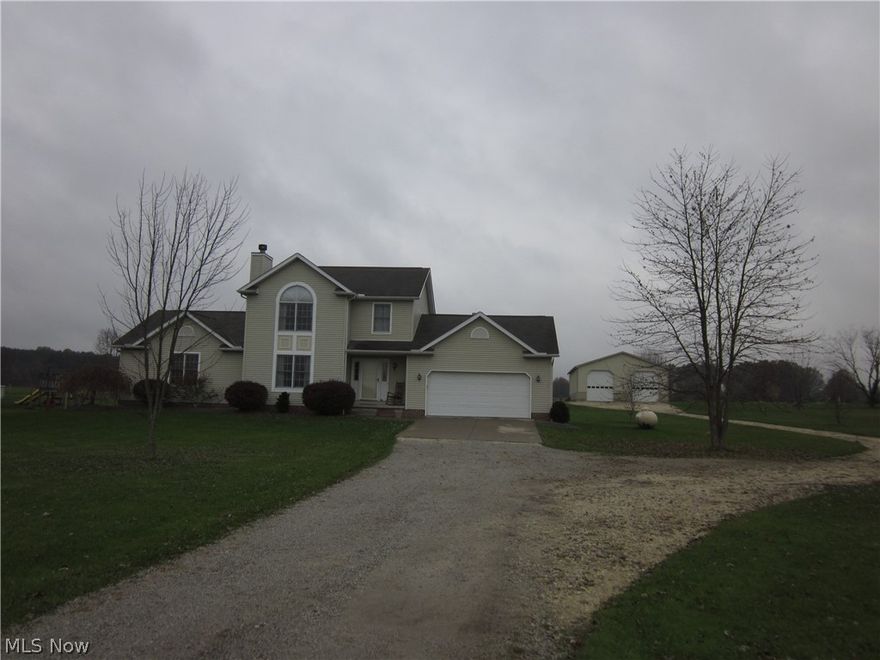 SPACIOUS 2 STORY with 4 bedrooms, 3.5 baths.   First floor owners suite and first floor laundry room, living room with fireplace, family room with pellet stone.   2.5 car attached garage plus a newer 40 x 64 outbuilding, concrete floor and car lift built in 2011 approx.  Beautiful brick patio.  OVER 2 ACRES!